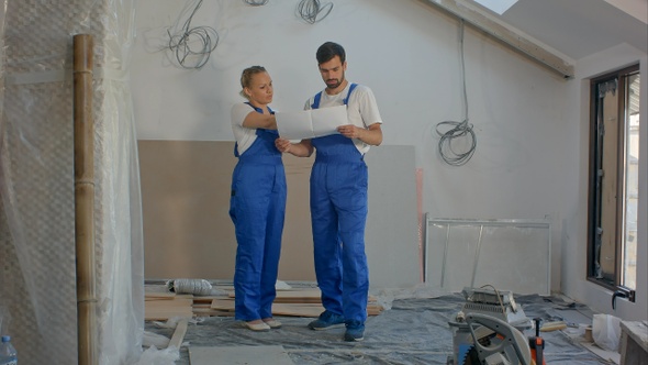 Architects working team holding a blueprints in house