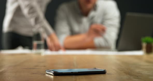 Man and woman working together and smartphone