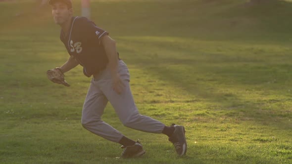 A young man playing catch with a baseball.