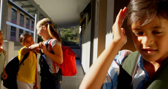 Schoolkids bullying a sad boy in the corridor of elementary school 4k