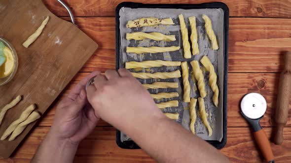 Putting seeds under the baked rolled dough.