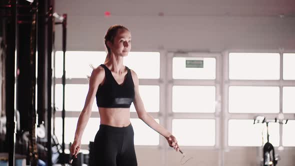 Slim Female Athlete Training At Fitness Club