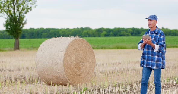 Agriculture Farmer Working on Field on Digital Tablet Computer