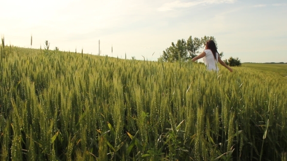 Happy Girl Running Through Wheat Field