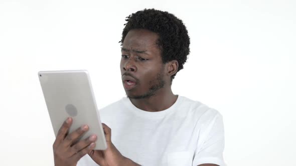 African Man Excited for Success While Using Tablet White Background