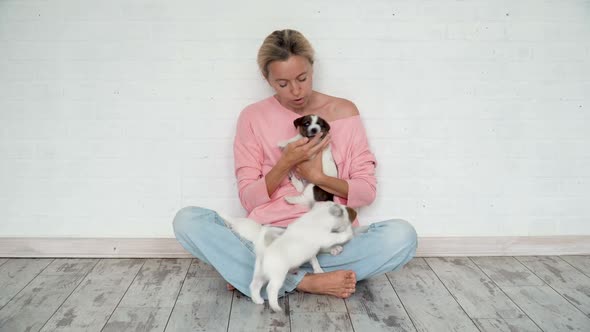 Owner with Group of Puppies at Home