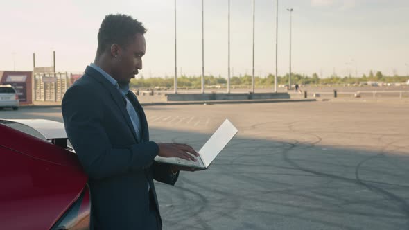 Close Up African American Man Holding Wireless Laptop While Leaning on His