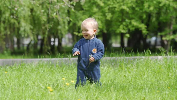 Happy Kid Playing on Green Grass on a Sunny Day 1