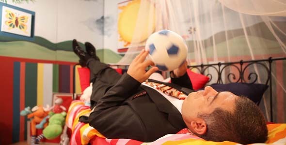 Mature Man Wearing Suit Playing With Ball