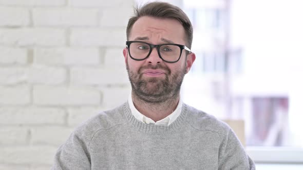 Portrait of Creative Man Saying No By Shaking Head