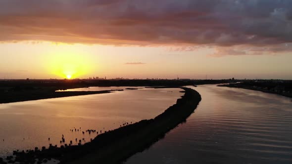Sunset captured by a drone while swallows are flying true the shot