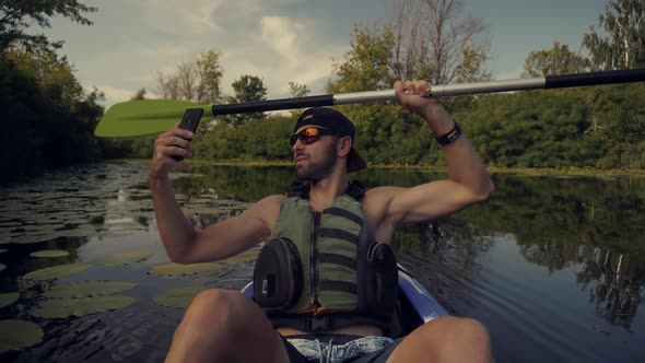 Man Taking Self Photo And Answer To Video Call In Canoe. Holiday Vacation Trip On Weekend.