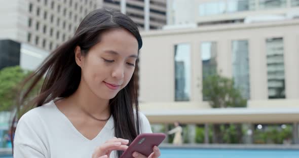 Woman look at mobile phone in Hong Kong