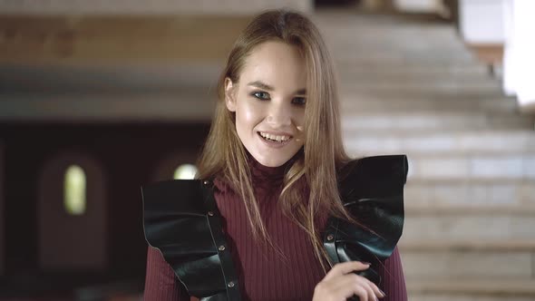Portrait of a Young Beautiful Girl Dressed in Leather Wings, Close-up