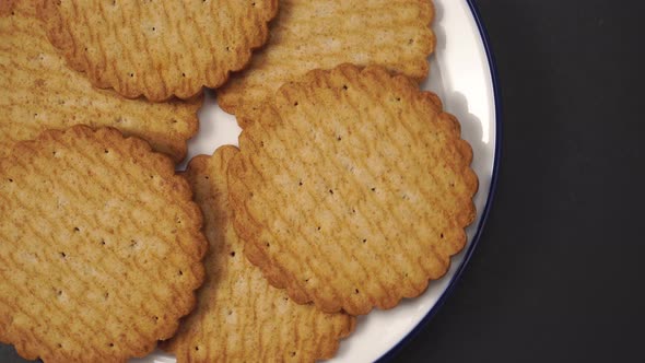 Appetizing golden shortbread cookies on a white plate