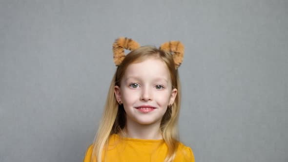 Cute Smiling Blond Girl with Tiger Ears