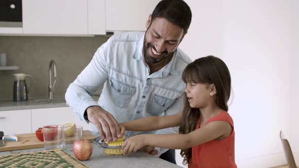 Joyful Dad and Daughter Enjoying Cooking Together