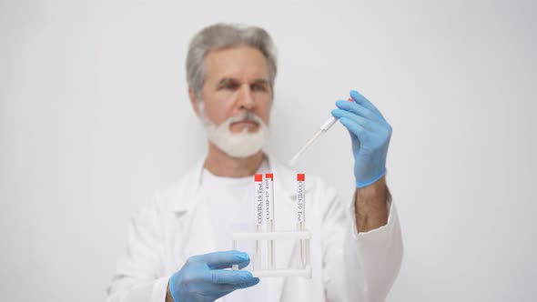 Senior Laboratory Officer Examines Integrity of Test Tubes for Coronavirus Test