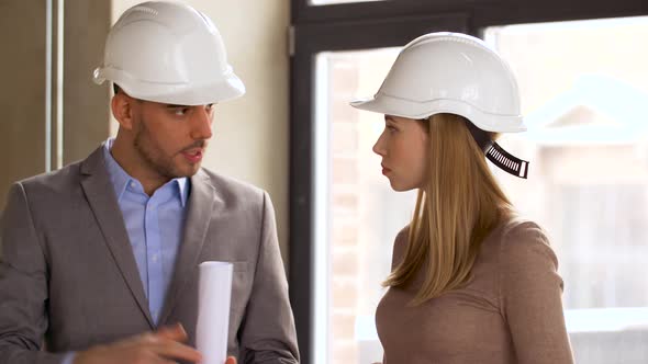 Architects with Blueprint and Helmets at Office 67