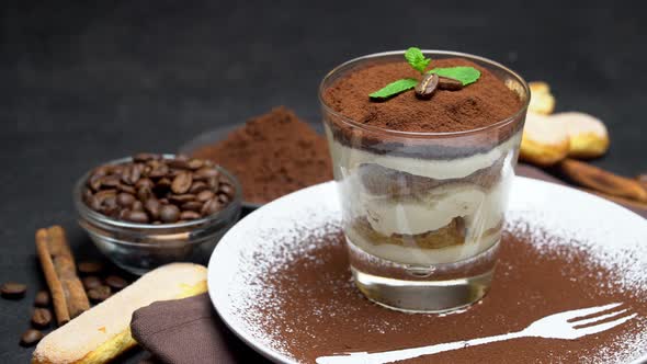 Classic Tiramisu Dessert in a Glass and Cup of Coffee on Dark Concrete Background