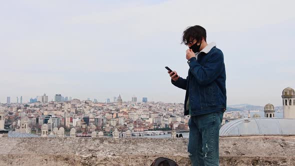 A Young Man Traveling in Turkey Walking to the Good Point of View and Taking a Photo of the City and