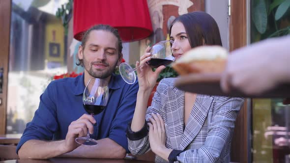 People In Restaurant. Couple Drinking Wine On Romantic Dinner