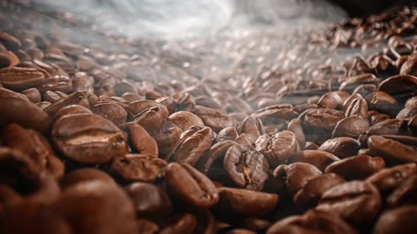 Close Up of Seeds of Coffee. Fragrant Coffee Beans Are Roasted Smoke Comes From Coffee Beans