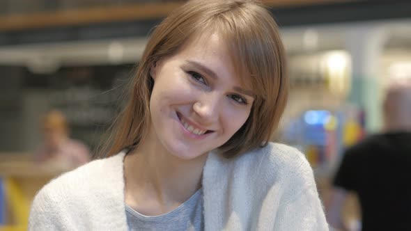 Smiling Young Woman Portrait in Cafe