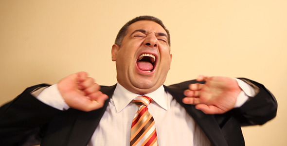 Tired Businessman Yawning And Stretching