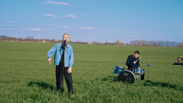 Musicians performing outdoors, playing music on field