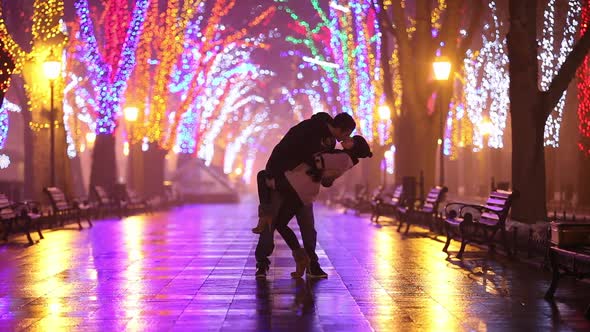 Couple with kissing at night alley in Odesa, Ukraine