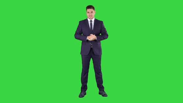 Handsome Businessman Looking in Camera and Talking on a Green Screen, Chroma Key