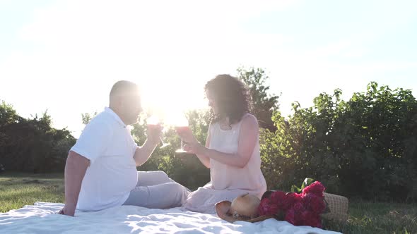 Mature Couple on a Picnic Date in the Garder