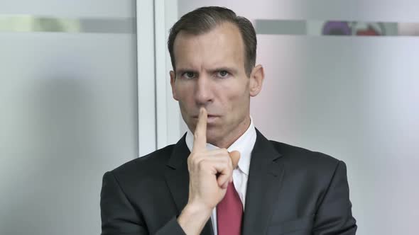 Finger on Lips Silence Gesture By Businessman