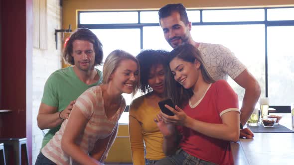 Friends at the bar in a pub taking a selfie