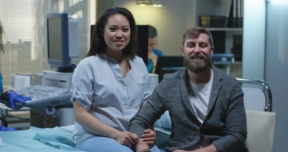 Pregnant Woman and Her Boyfriend Smiling at Camera