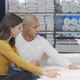 Happy Couple Examining Orthopedic Mattress on Sale at Furnishings Store - VideoHive Item for Sale