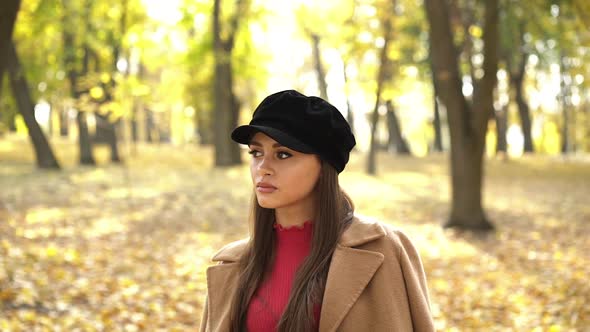 The Brunette Posing and Caressing Herself at Camera in Sunny Autumn Park