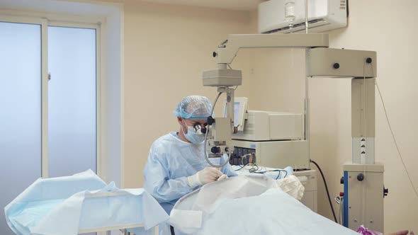 Alone Surgeon Is Sitting in Operating Room Near Table with Patient