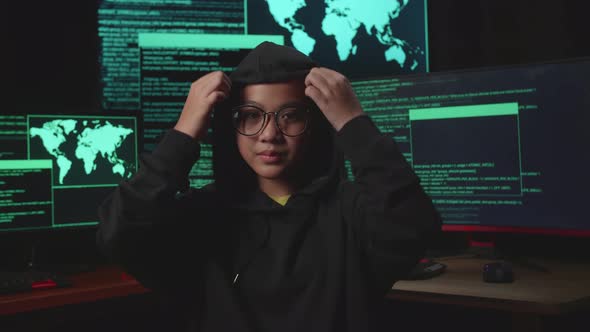 Asian Young Girl Hacker Hacking With Multiple Computer Screens And Pose In Dark Room