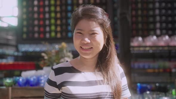 asian female small business owner happiness smiling standing ready to reopen shop