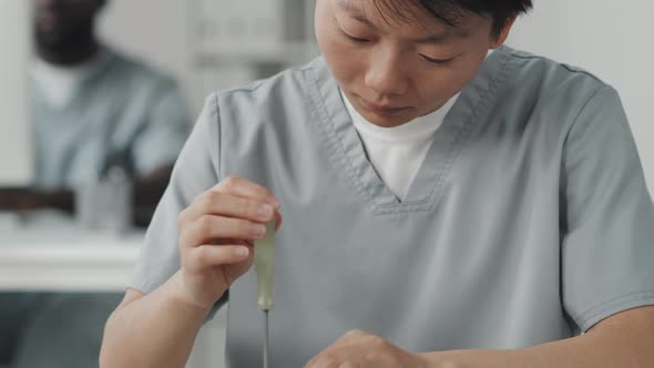 Asian Female Engineer Repairing Circuit Board