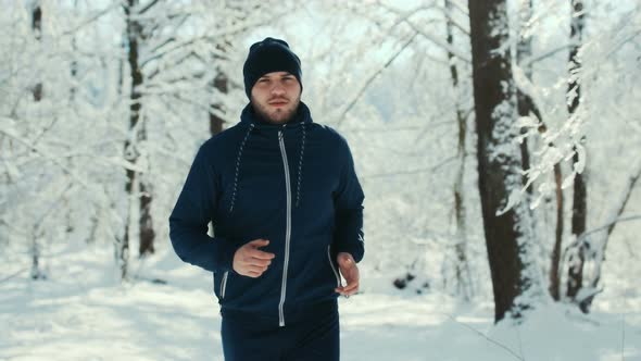 Sport Man Running In Winter City Park During Morning Jog