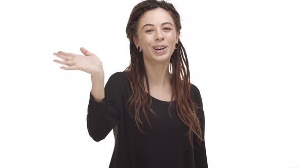 Video of Attractive Modern Girl with Dreadlocks and Ear Tunnels Wearing Black Blouse Saying Hello