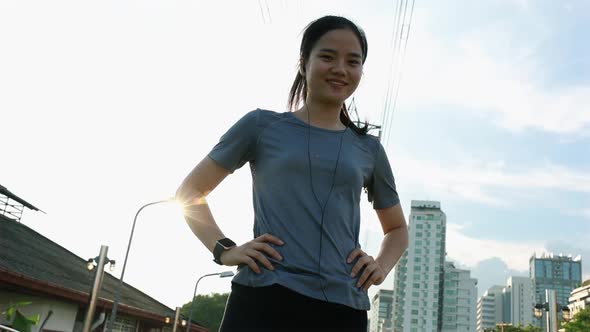 Smiling young Asian woman athlete looking at the camera.