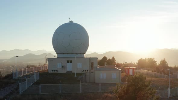 Giant radome sphere that protects radar antenna and airspace monitoring equipment, sunrise or sunset