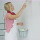 Smiling Woman Painting Wall Yellow - VideoHive Item for Sale