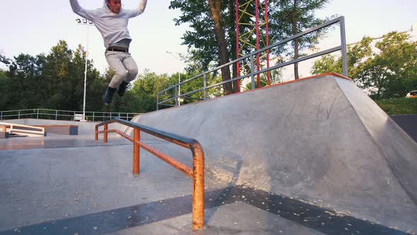 Aggressive Inline Roller Skater Doing Tricks in Concrete Skatepark Outdoors Slow Motion