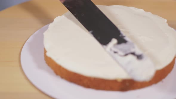 Applying the Cream to the Sponge Cake During the Assembly of the Cake