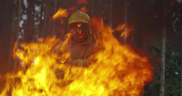 Portrait of Firefighter with Full Equipment Holds the Axe in His Hand